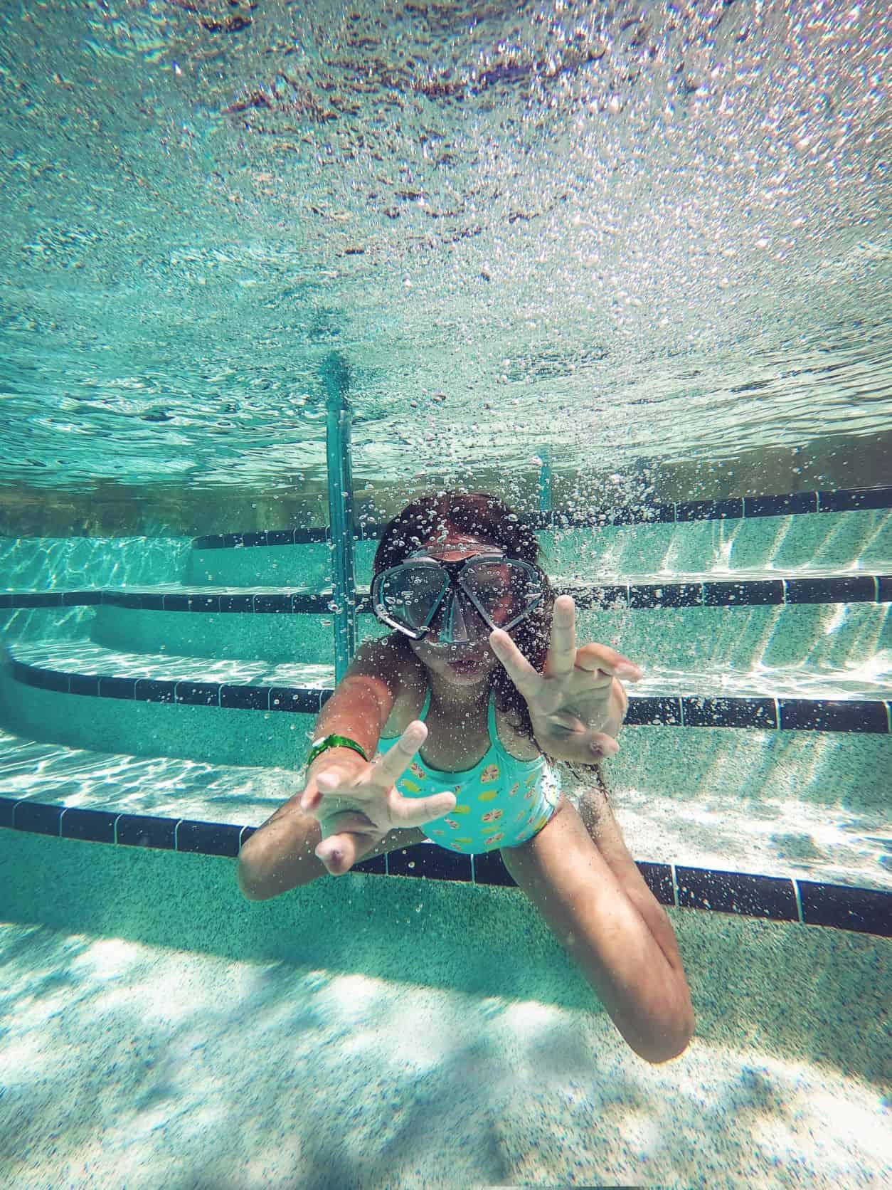 girl underwater with EWG Approved Sunscreen 