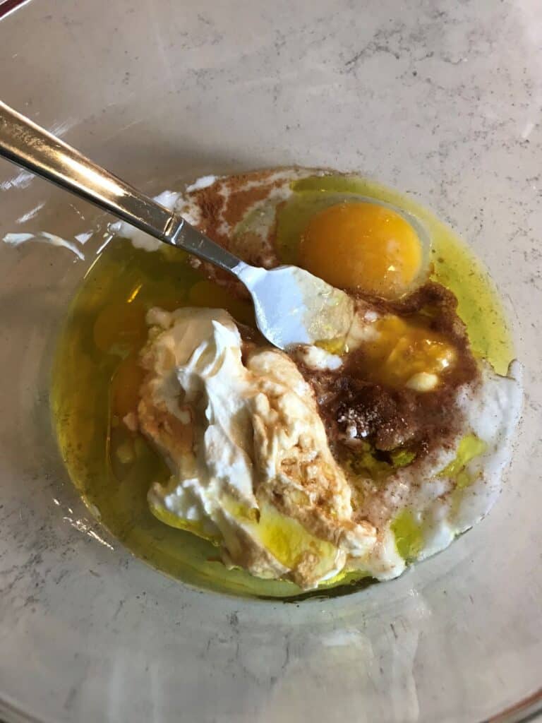 eggs, yogurt and olive oil in glass bowl 