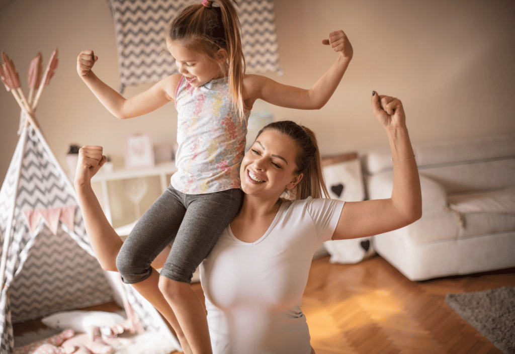 Mom and daughter making muscles 