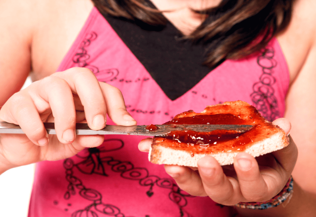 woman eating naked carbs, bread and jam