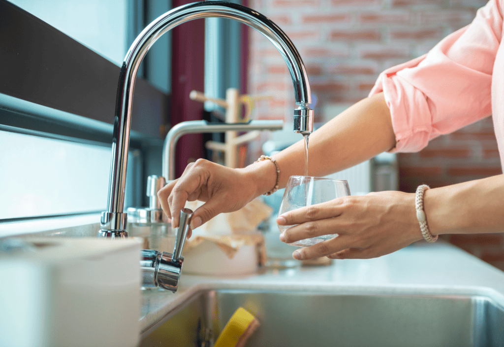 woman at sink running water