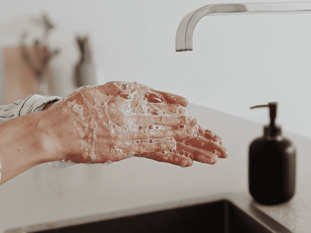 woman washing hands with non-toxic hand soap that is synthetic fragrance free