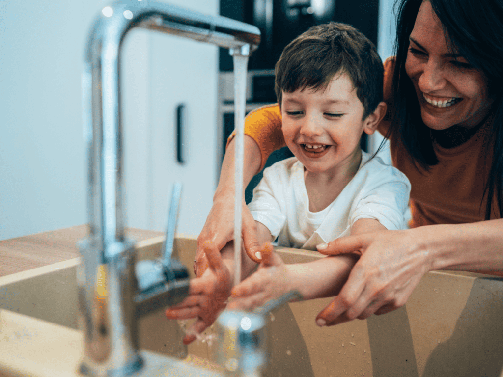 mom and son washing hands with naturally scented hand soap